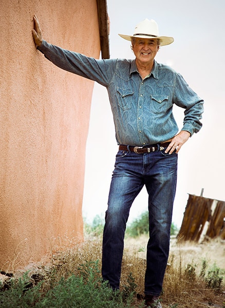 Author Tom Tatum Leaning Against Adobe Wall